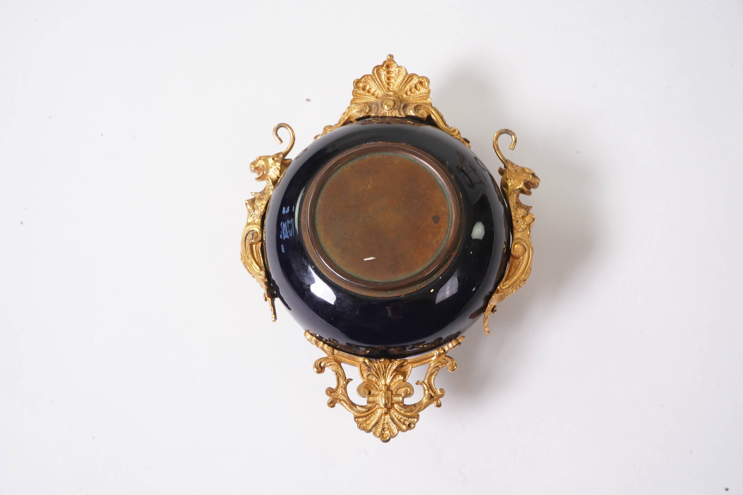 An unusual enamel and gilt brass timepiece, pendant from gilt brass frame, stand 26cm high. Condition - dismantled